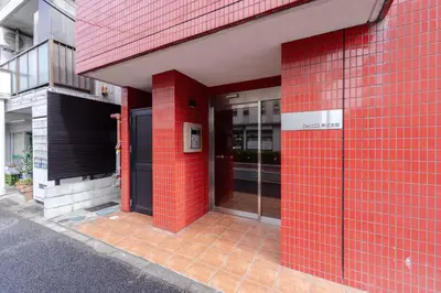 a red brick facade of a building with a door at House Hotel Shin Ekoda401 DE41 in Tokyo