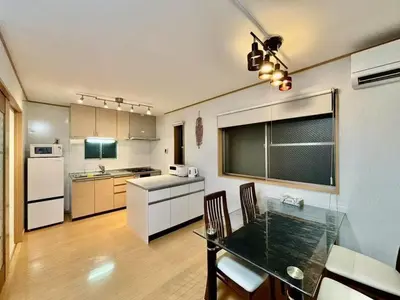 a kitchen with a table and chairs in a room at Quiet and beautiful house nearby Tokyo Skytree in Tokyo