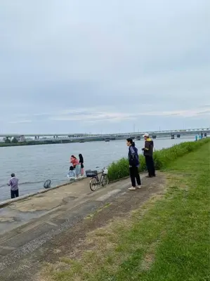a group of people standing on a path by the water at Quiet and beautiful house nearby Tokyo Skytree in Tokyo