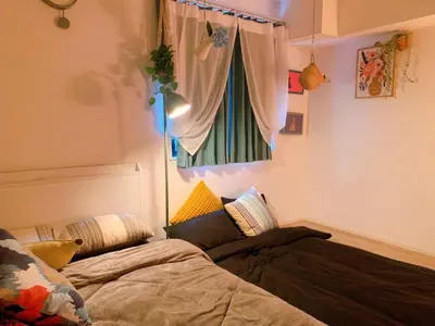 a bedroom with a bed and a window at Harajuku house in Tokyo