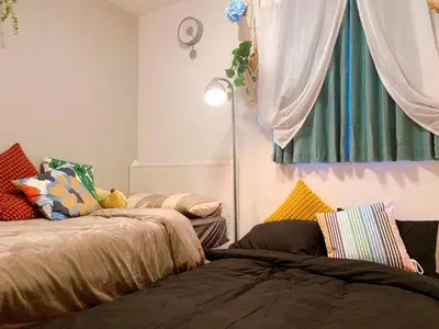 a room with two beds and a window at Harajuku house in Tokyo