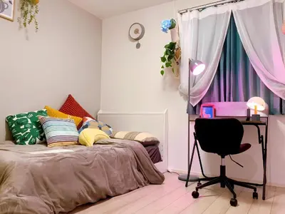 a bedroom with a bed and a desk and a chair at Harajuku house in Tokyo