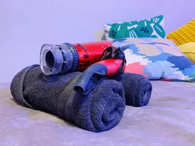 a bottle and glasses sitting on top of a towel at Harajuku house in Tokyo