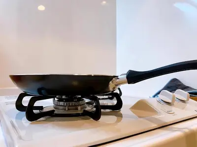 a wok on a stove with a pan on it at Harajuku house in Tokyo