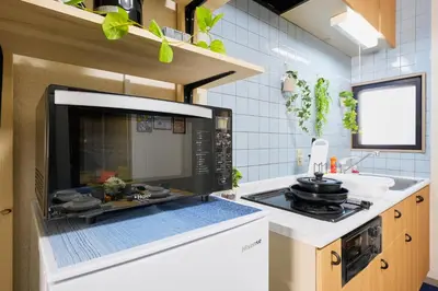 a kitchen with a microwave oven and a stove at Shamrock Aoto 304 Cozy Tokyo Stay Near Station Airport Disney Access in Tokyo