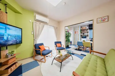 a living room with a couch and chairs and a tv at Shamrock Aoto 304 Cozy Tokyo Stay Near Station Airport Disney Access in Tokyo