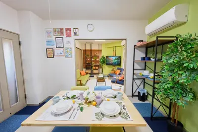 a living room with a table with plates on it at Shamrock Aoto 304 Cozy Tokyo Stay Near Station Airport Disney Access in Tokyo