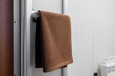 a towel hanging on the door of a refrigerator at Opening January 2026 Just a five minute walk from Tabata Station on the Yamanote Line with direct access to Ikebukuro Shinjuku Shibuya and Ueno Comfortably sleeps 3 accommodates up to five guests in Tokyo