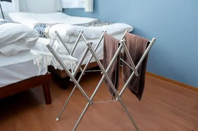 a chair with towels on it next to two beds at Opening January 2026 Just a five minute walk from Tabata Station on the Yamanote Line with direct access to Ikebukuro Shinjuku Shibuya and Ueno Comfortably sleeps 3 accommodates up to five guests in Tokyo