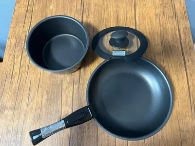 a frying pan and a cup on a table at Opening January 2026 Just a five minute walk from Tabata Station on the Yamanote Line with direct access to Ikebukuro Shinjuku Shibuya and Ueno Comfortably sleeps 3 accommodates up to five guests in Tokyo