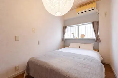 a small bedroom with a bed and a window at Maison Shin Nakano 101 MS11 in Tokyo