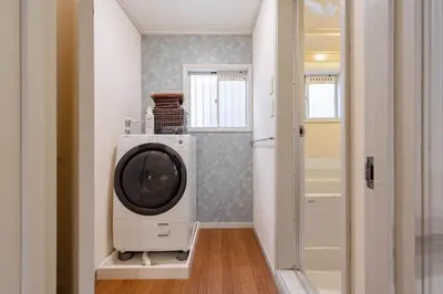 a washing machine in a room with a door at Maison Shin Nakano 101 MS11 in Tokyo