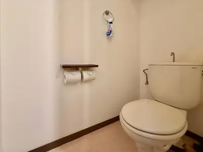 a bathroom with a toilet and two rolls of toilet paper at \u30a8\u30de\u30fc\u30ec\u6771\u5c0f\u5ca9101 \u5c0f\u5ca9\u99c5\u5f92\u6b695\u5206 \u6700\u59277\u540d \u548c\u5ba4\u7573 in Tokyo