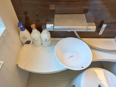 a bathroom with a toilet and bottles on a counter at Yadoya Asakusa Kokeshian in Tokyo