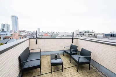 a balcony with chairs and a table on a building at Hatagaya Honmachi house \u6da9\u8c37-SY0488 in Tokyo