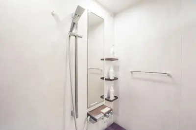 a bathroom with a shower with a mirror at Hatagaya Honmachi house \u6da9\u8c37-SY0488 in Tokyo