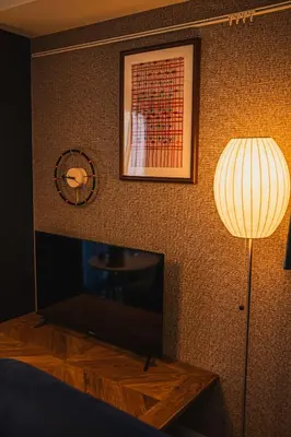 a bedroom with a lamp and a table and a picture at Svalley YIG stay 401 in Tokyo