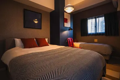 a hotel room with a large bed and a window at Svalley YIG stay 401 in Tokyo