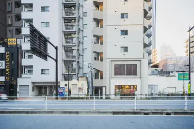 an empty street in a city with tall buildings at Svalley YIG stay 401 in Tokyo