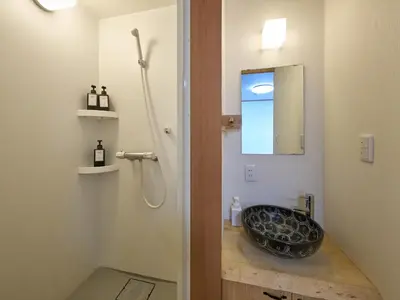 a bathroom with a sink and a shower at Yadoya Asakusa Darumaan in Tokyo