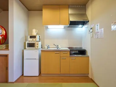 a small kitchen with a sink and a microwave at Yadoya Asakusa Darumaan in Tokyo