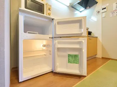 a white refrigerator with its door open in a kitchen at Yadoya Asakusa Darumaan in Tokyo