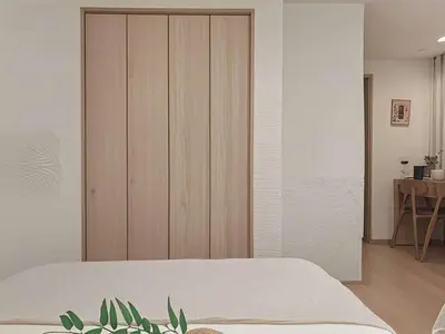 a bedroom with a bed and a wooden cabinet at Grace Tokyo Yazen located at Ikebukuro Station Direct access to Shinjuku and Shibuya Comfortable and convenient for travel in Tokyo