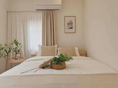 a bedroom with a white bed with a plant on it at Grace Tokyo Yazen located at Ikebukuro Station Direct access to Shinjuku and Shibuya Comfortable and convenient for travel in Tokyo