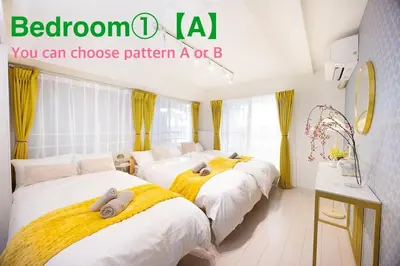 two beds in a room with yellow and white at Kagisippo yushima in Tokyo