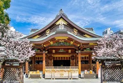 a temple in a city with flowering trees at Kagisippo yushima in Tokyo