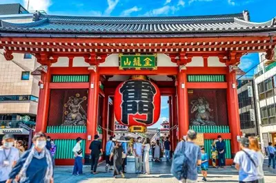 a group of people walking in front of a building at Kagisippo yushima in Tokyo