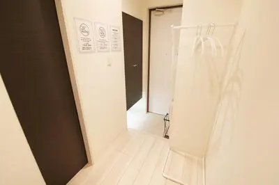 a room with a hallway with a door and a mirror at Espada KAMEARI 103 in Tokyo