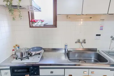 a kitchen sink with a pan on a stove at 203 Room, a 6-minute walk from Tokyo Koiwa Station Direct connected to Shinjuku and Akihabara Stations Comfortable one-bedroom apartment with separate wet and dry areas in Tokyo