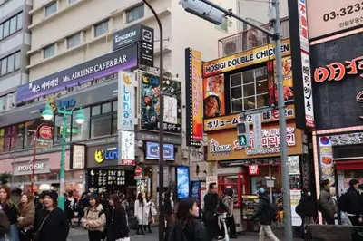 a crowd of people walking down a busy city street at Hotel SHINJYUKU in Tokyo