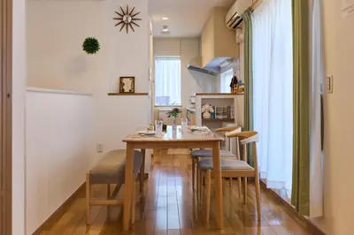 a dining room with a wooden table and chairs at Hotel \u30d5\u30eb\u30fc\u30eb301 in Tokyo