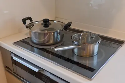 two pots and pans sitting on top of a stove at Hotel \u30d5\u30eb\u30fc\u30eb301 in Tokyo