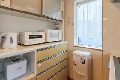 a small kitchen with appliances on a counter at Hotel \u30d5\u30eb\u30fc\u30eb301 in Tokyo