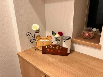 a hotel sign sitting on top of a counter at Hotel \u30d5\u30eb\u30fc\u30eb301 in Tokyo