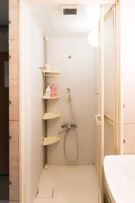 a bathroom with a shower and a sink at Raiya Stay at Machiya in Tokyo
