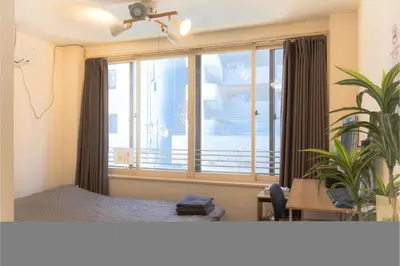a room with a bed and a large window at Raiya Stay at Machiya in Tokyo