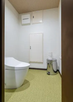 a bathroom with a toilet and a sign on the wall at Js Asakusa 6-minute walk from Asakusa Station in Tokyo