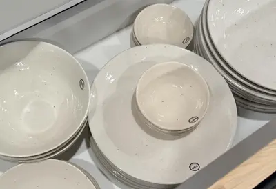 a pile of white plates and bowls in a drawer at Js Asakusa 6-minute walk from Asakusa Station in Tokyo