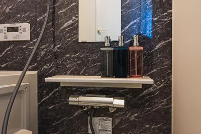a bathroom with two bottles on a wall at Omotenashi HOTEL FamilyStay in Tokyo