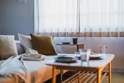 a living room with a couch and a coffee table at Omotenashi HOTEL FamilyStay in Tokyo
