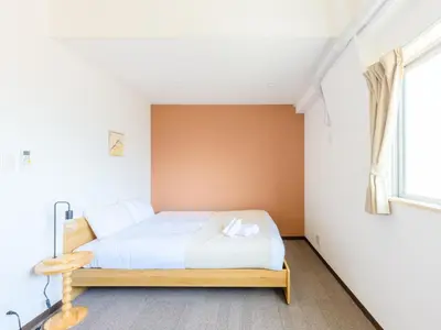 a bedroom with a white bed and a window at Hotel Shibamata Tokyo in Tokyo