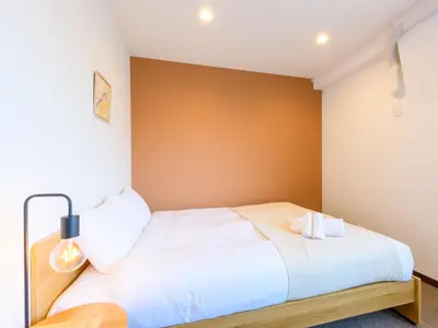 a bedroom with a bed with two candles on it at Hotel Shibamata Tokyo in Tokyo