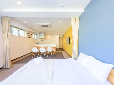 a bedroom with a large bed and a table at Hotel Shibamata Tokyo in Tokyo