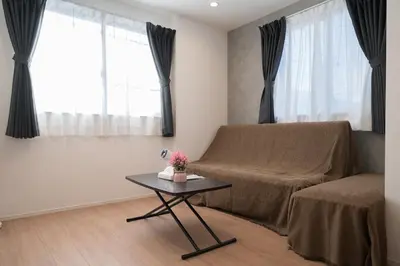 a living room with a bed and a table at 3BRBig House for 7 2 Stops Direct to Tokyo Skytree EntireHome in Sumida in Tokyo