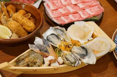 a tray of oysters and other foods on a table at 3BRBig House for 7 2 Stops Direct to Tokyo Skytree EntireHome in Sumida in Tokyo