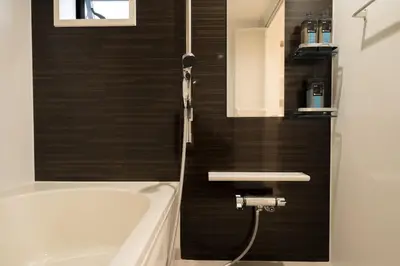 a bathroom with a bath tub and a sink at 3BRBig House for 7 2 Stops Direct to Tokyo Skytree EntireHome in Sumida in Tokyo